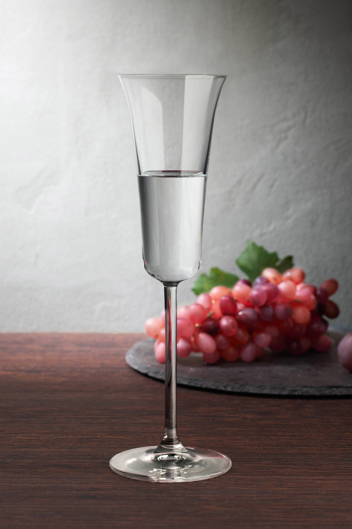 Long body, modern Grappa Glass with a long stem on a dining table.