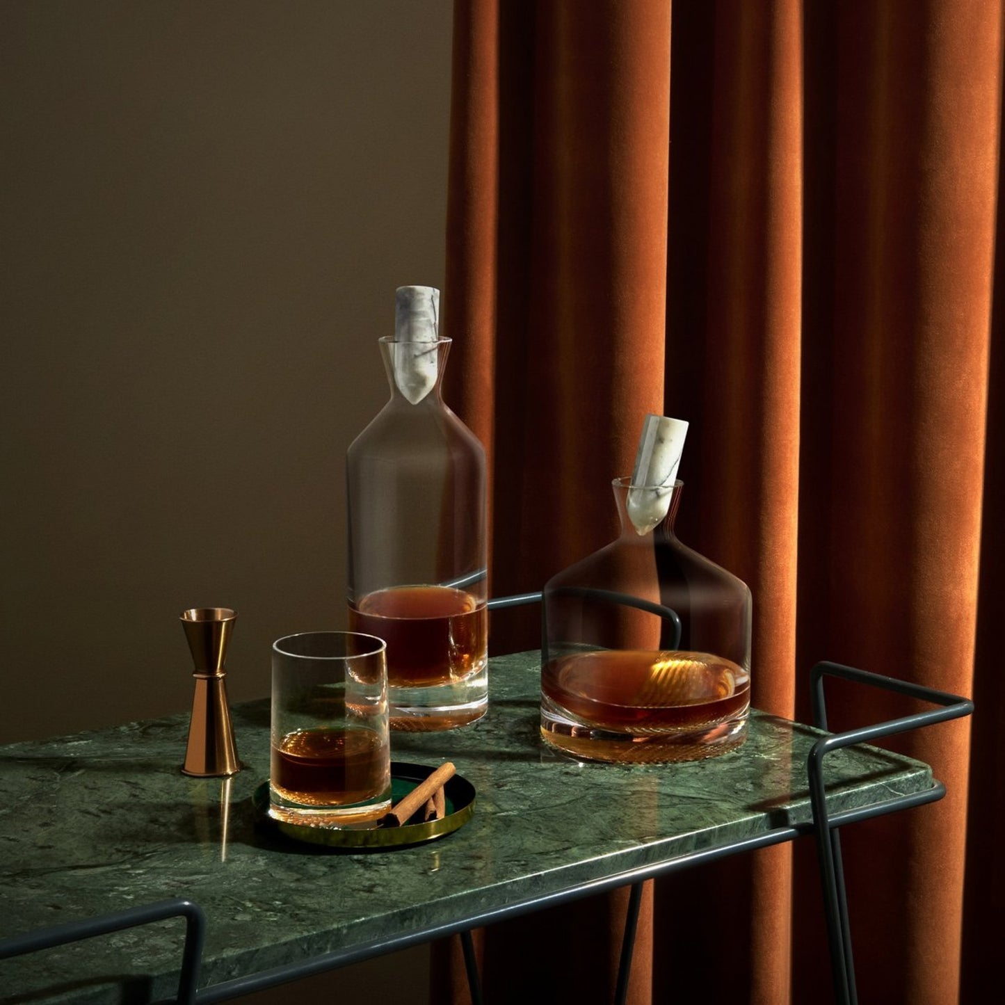 Whiskey cocktail set - complete with the tall, wide, glass version with its signature decorative facet paired next to a bronze jigger.