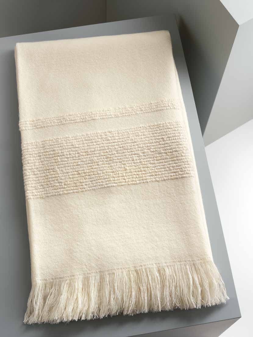 Cashmere / wool blend cream throw with textured pattern and fringes.