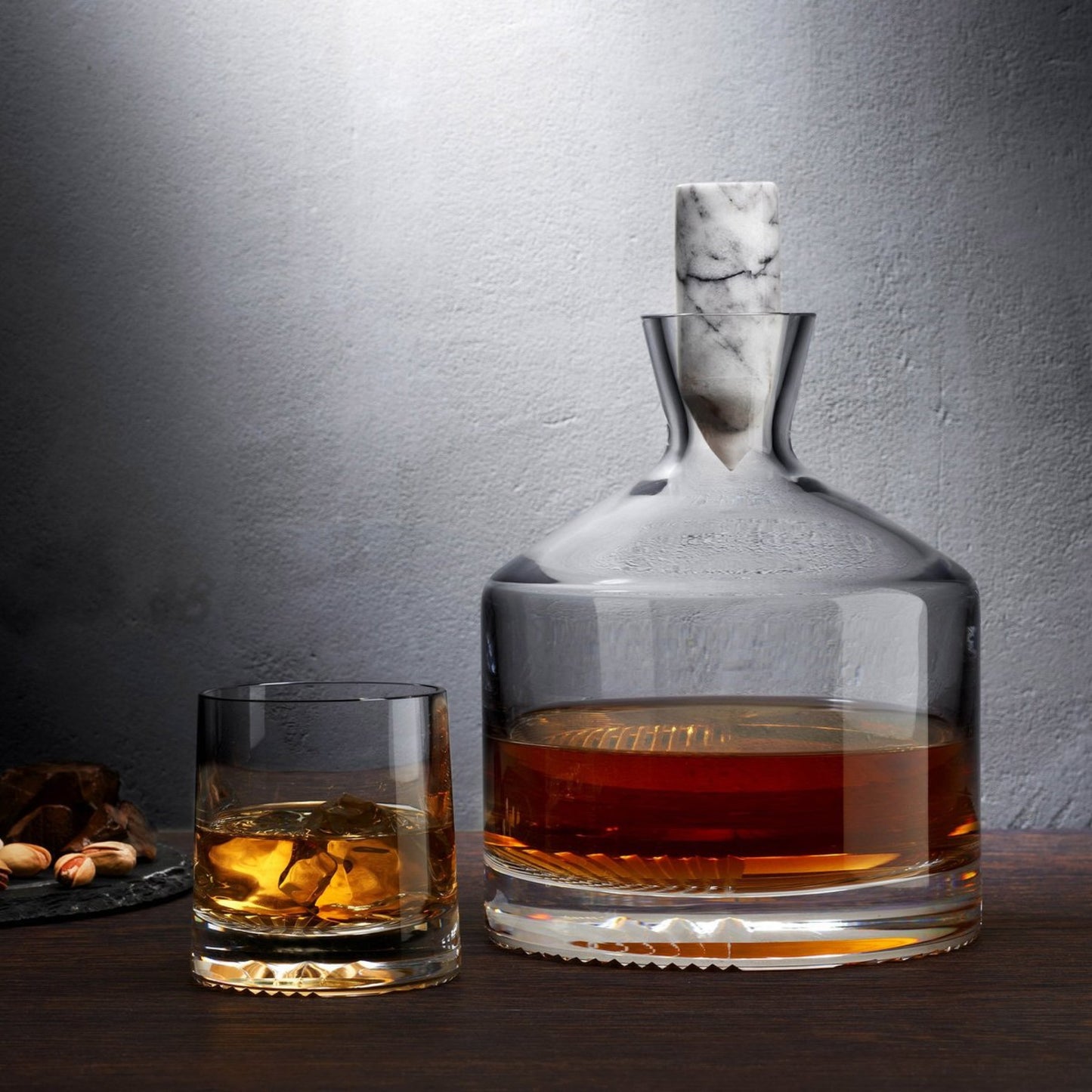 Alba Whiskey decanter with signature decorative facet paired with matching Alba glass in mood lighting.