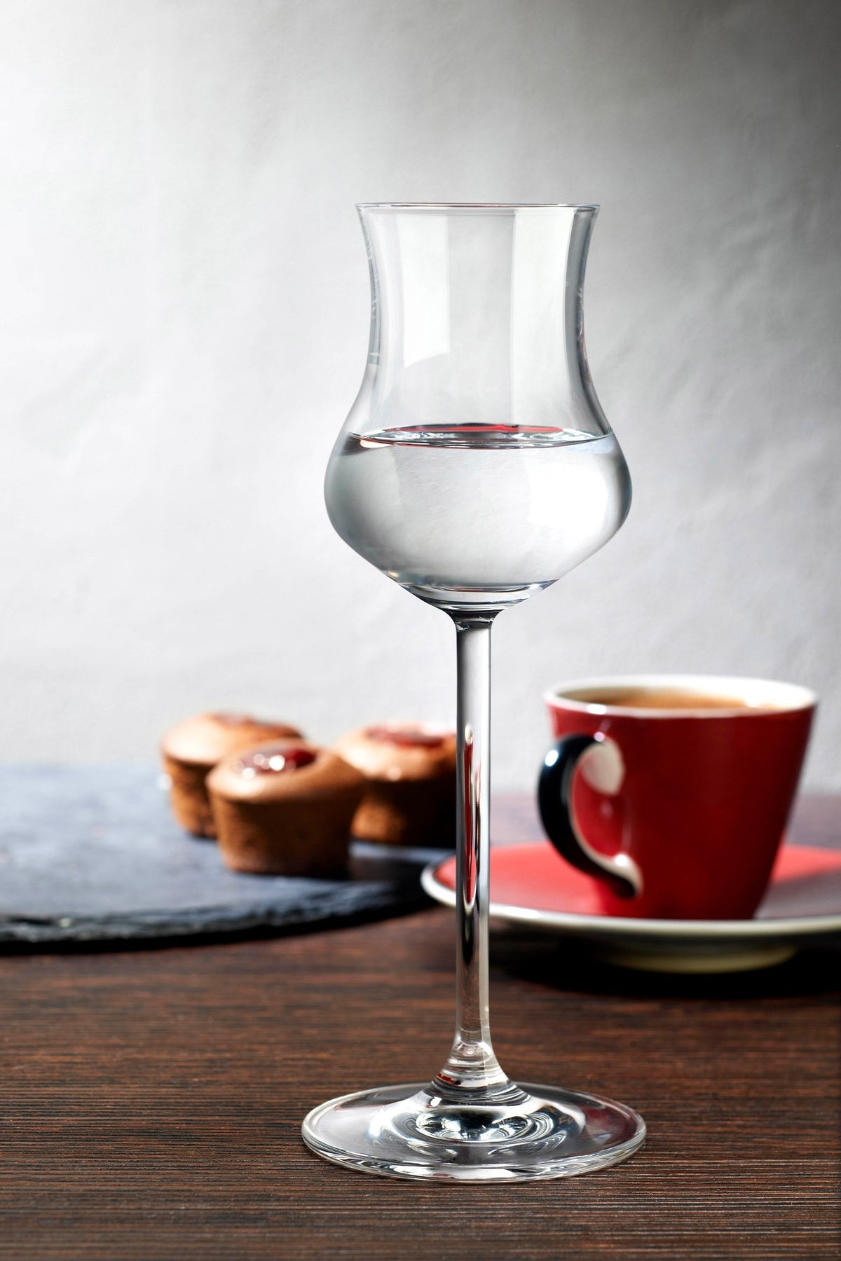 Modern Grappa glass on dining table setting.
