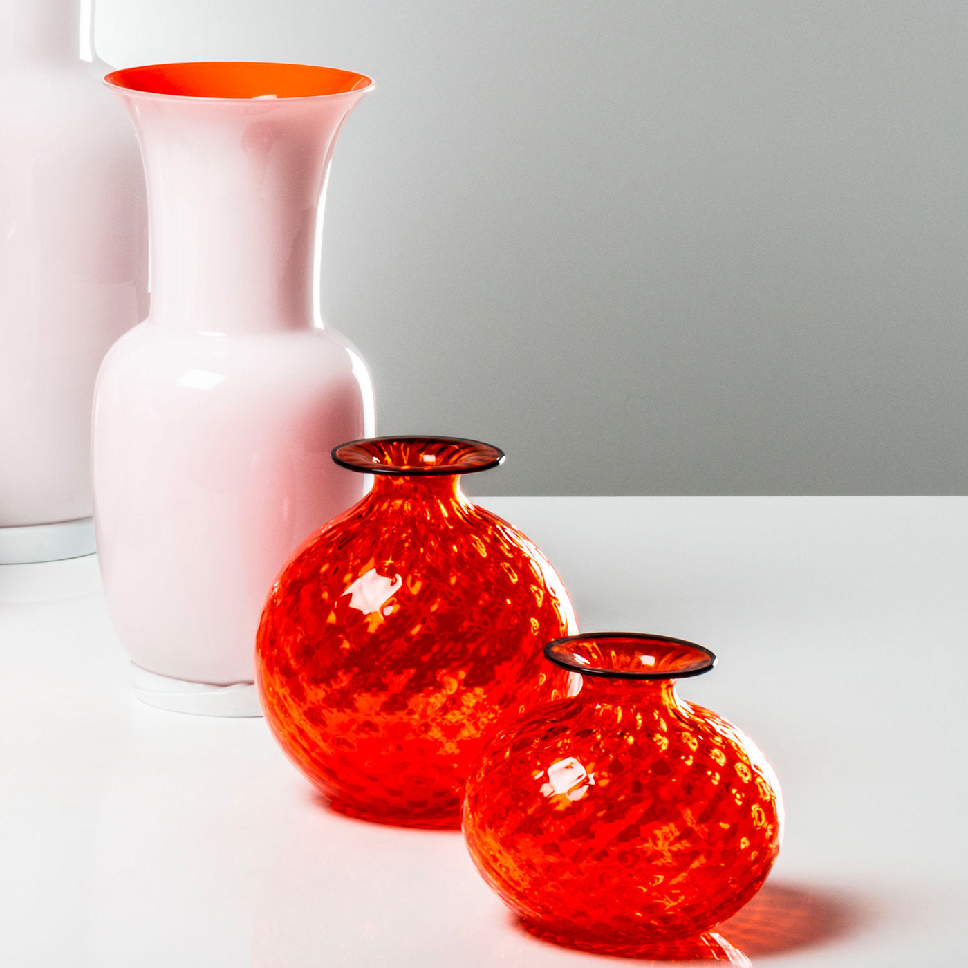 Pair of red round etched glass vases with colored lip crafted from Murano, Italy.