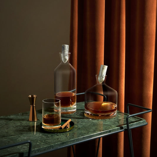 Whiskey cocktail set - complete with the tall, wide, glass version with its signature decorative facet paired next to a bronze jigger.